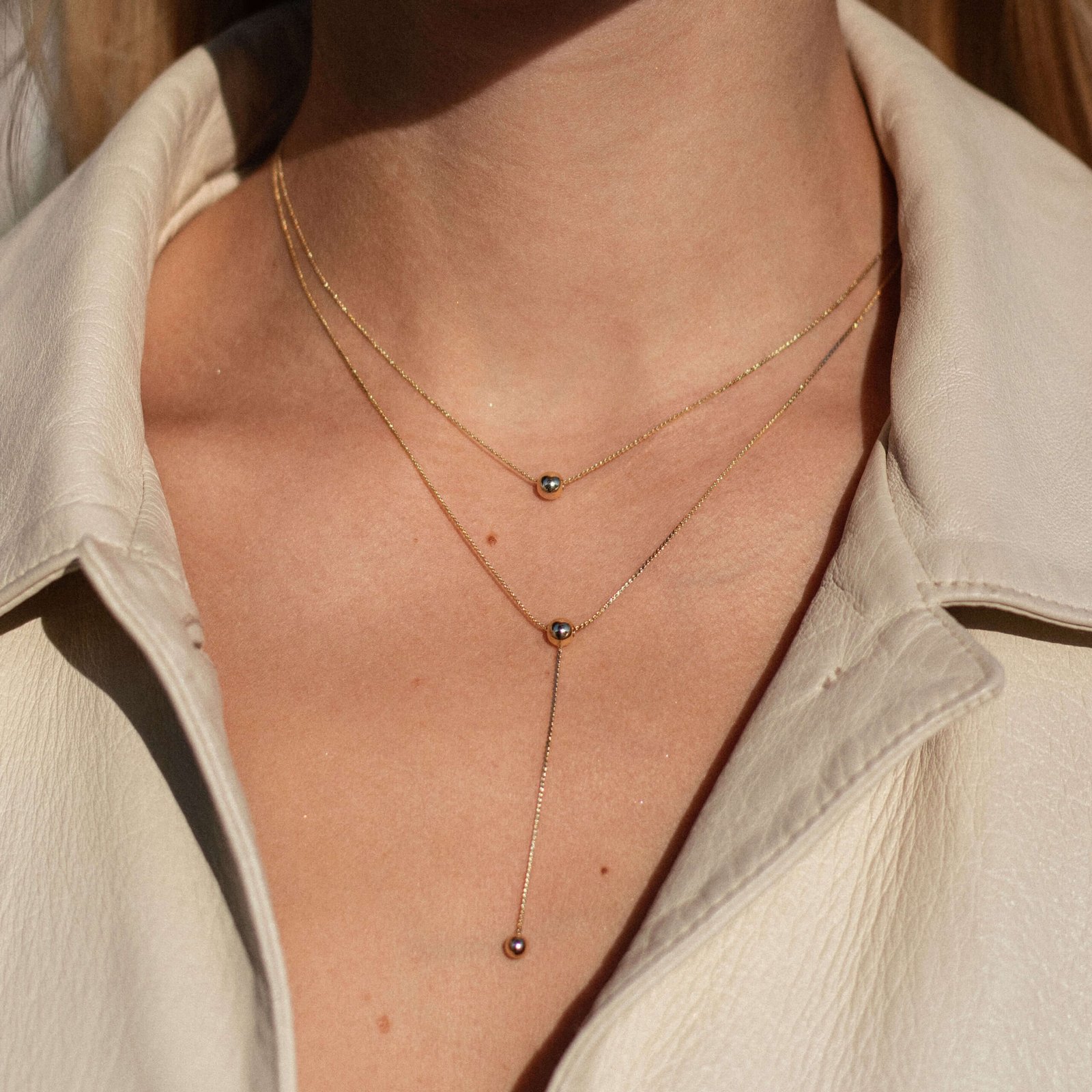 gold-necklace-adorned-with-two-ball-pendant.jpg