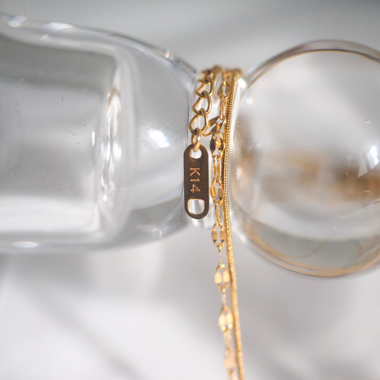 zabrina-double-chain-necklace-shimmering-gold-chain-with-a-petite-gold-charm.jpg